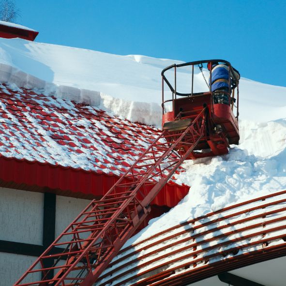 Snow damage on a roof, highlighting roofing repair needs